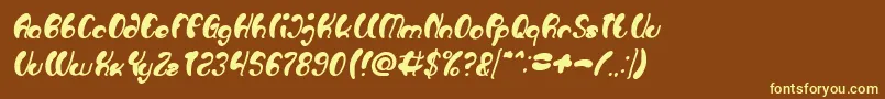 Luxurious Sexy Bold Italic-fontti – keltaiset fontit ruskealla taustalla