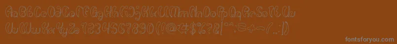 Luxurious Sexy Hollow-fontti – harmaat kirjasimet ruskealla taustalla