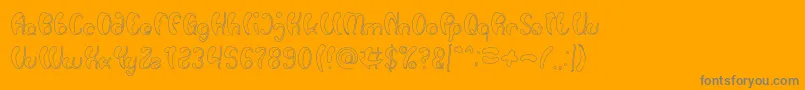 Шрифт Luxurious Sexy Hollow – серые шрифты на оранжевом фоне