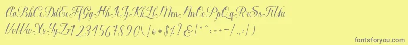 Macrofhyllya Script-fontti – harmaat kirjasimet keltaisella taustalla