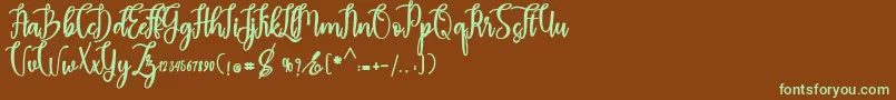 フォントmadam – 緑色の文字が茶色の背景にあります。
