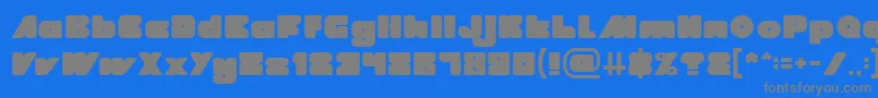 MADE IN EARTH-fontti – harmaat kirjasimet sinisellä taustalla