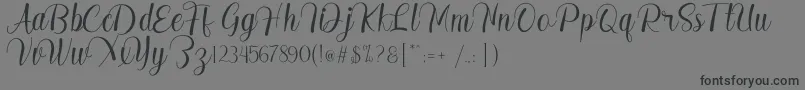 Czcionka Madelyn – czarne czcionki na szarym tle