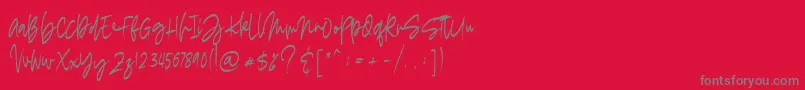 madigel free-fontti – harmaat kirjasimet punaisella taustalla