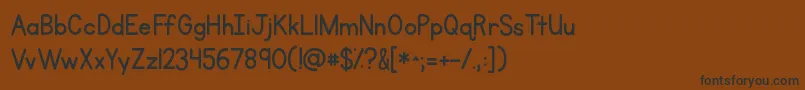 フォントKgprimarypenmanship – 黒い文字が茶色の背景にあります