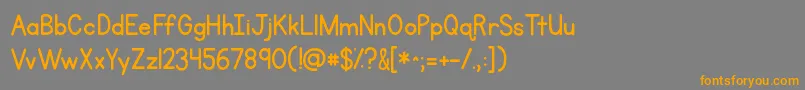 フォントKgprimarypenmanship – オレンジの文字は灰色の背景にあります。