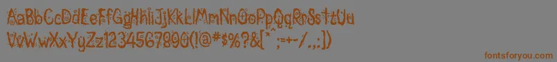 フォントMagician – 茶色の文字が灰色の背景にあります。