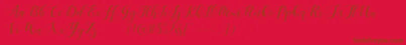 Fonte Maheisa Script Free – fontes marrons em um fundo vermelho