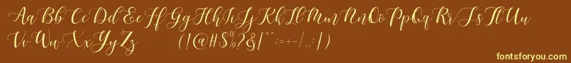 Maheisa Script Free-fontti – keltaiset fontit ruskealla taustalla