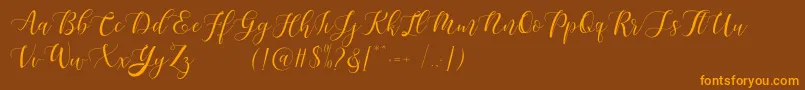 Maheisa Script Free-fontti – oranssit fontit ruskealla taustalla