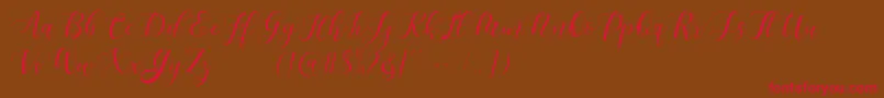 Czcionka Maheisa Script Free – czerwone czcionki na brązowym tle