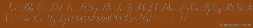 フォントMaheria Script – 茶色の背景に灰色の文字