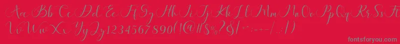 Maheria Script-fontti – harmaat kirjasimet punaisella taustalla