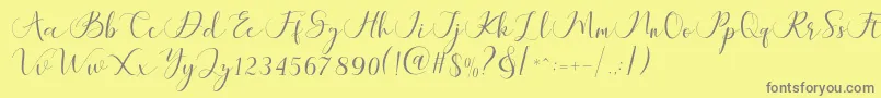 Maheria Script-Schriftart – Graue Schriften auf gelbem Hintergrund