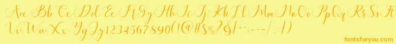 フォントMaheria Script – オレンジの文字が黄色の背景にあります。