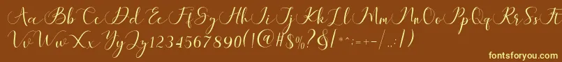 フォントMaheria Script – 黄色のフォント、茶色の背景