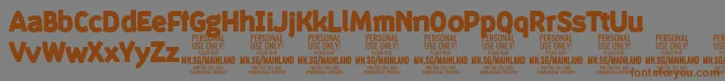 フォントMainlandBlack PERSONAL – 茶色の文字が灰色の背景にあります。