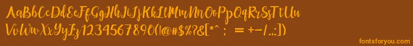 maisha script Demo Font – Orange Fonts on Brown Background