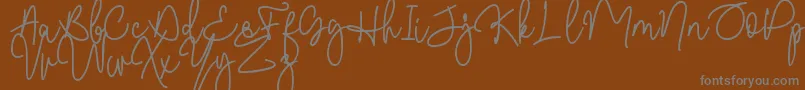 Czcionka Malibbie DAFONT – szare czcionki na brązowym tle