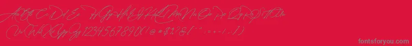 Manchester Signature-fontti – harmaat kirjasimet punaisella taustalla