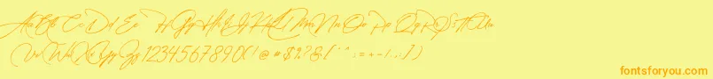 フォントManchester Signature – オレンジの文字が黄色の背景にあります。