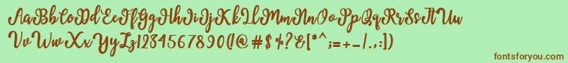 Fonte Manda Script – fontes marrons em um fundo verde