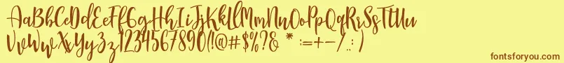 フォントManda – 茶色の文字が黄色の背景にあります。