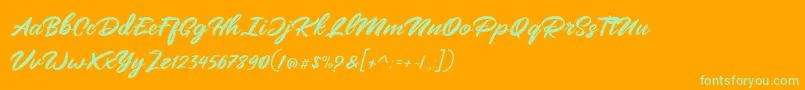 Mangotea   FREE PERSONAL USE-Schriftart – Grüne Schriften auf orangefarbenem Hintergrund