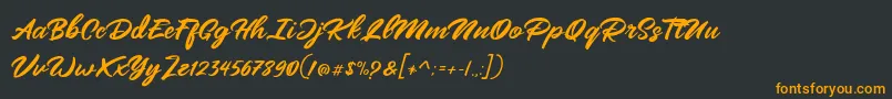 Mangotea   FREE PERSONAL USE-Schriftart – Orangefarbene Schriften auf schwarzem Hintergrund