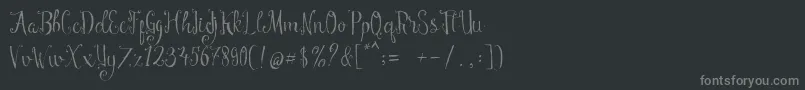 Manny Script-fontti – harmaat kirjasimet mustalla taustalla