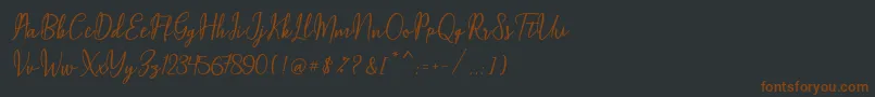 フォントMaqella Script – 黒い背景に茶色のフォント