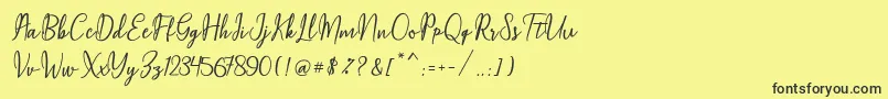Czcionka Maqella Script – czarne czcionki na żółtym tle
