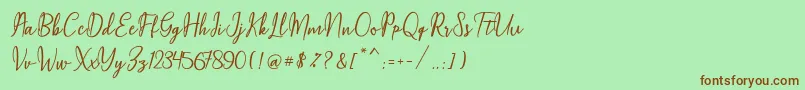 Maqella Script Font – Brown Fonts on Green Background