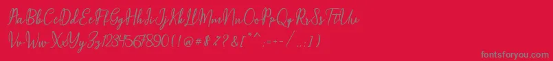 Czcionka Maqella Script – szare czcionki na czerwonym tle