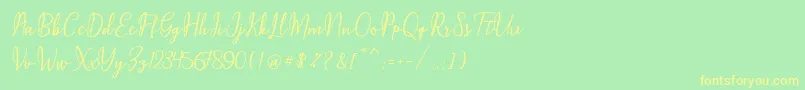 フォントMaqella Script – 黄色の文字が緑の背景にあります