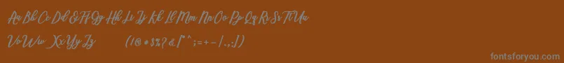 Marcela Script Font – Gray Fonts on Brown Background