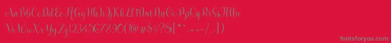 フォントMarcellina Script – 赤い背景に灰色の文字