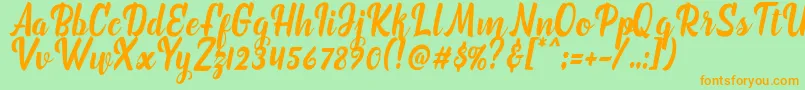 フォントmarchelina script – オレンジの文字が緑の背景にあります。