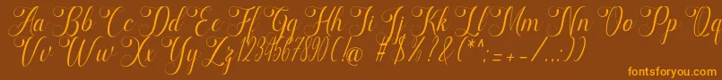 フォントmarketing – オレンジ色の文字が茶色の背景にあります。
