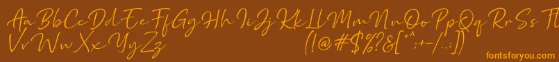 フォントMarthin – オレンジ色の文字が茶色の背景にあります。