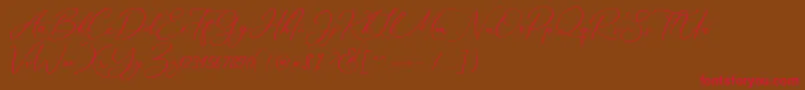 フォントMarverlous Script Demo – 赤い文字が茶色の背景にあります。