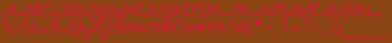 フォントmaya – 赤い文字が茶色の背景にあります。