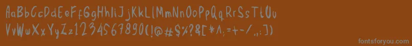 フォントMbak Mbik1 Hitam – 茶色の背景に灰色の文字