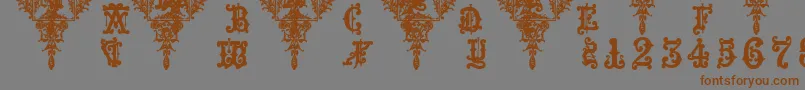 フォントMedieval Sorcerer Ornamental – 茶色の文字が灰色の背景にあります。