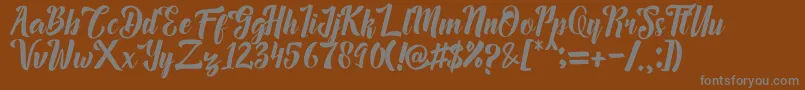 Megalia-fontti – harmaat kirjasimet ruskealla taustalla