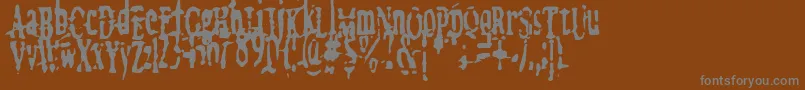 megalomania   x-fontti – harmaat kirjasimet ruskealla taustalla