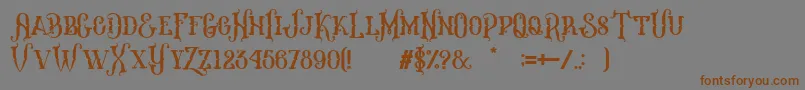 フォントMelanesia Regular – 茶色の文字が灰色の背景にあります。