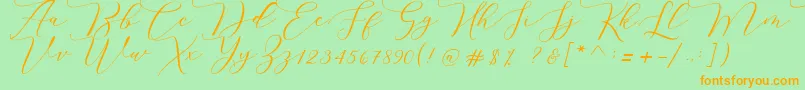 Czcionka Melinda script – pomarańczowe czcionki na zielonym tle