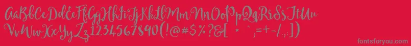 Mellanie Free Sample-Schriftart – Graue Schriften auf rotem Hintergrund