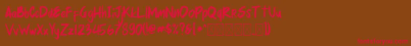 フォントmellurack – 赤い文字が茶色の背景にあります。